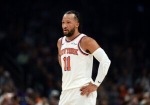 Jalen Brunson stands with hands on hips.