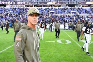 John Harbaugh walks off the field.