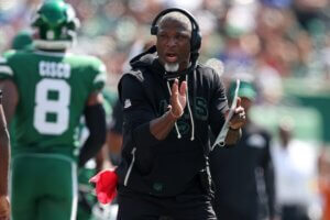 Head coach Aaron Glenn claps his hands.
