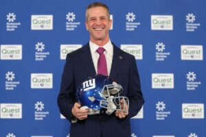 John Harbaugh with a Giants helmet.