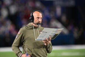 Matt Nagy holds up a playsheet.