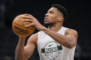 Milwaukee Bucks star Giannis Antetokounmpo holds the ball.