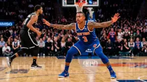 OG Anunoby in Knicks uniform playing intense defense during NBA playoff game