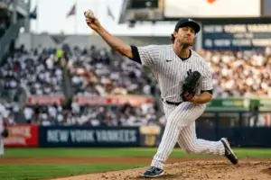 Yankees left-handed pitcher Max Fried throwing from the mound during game with focus on pitching arm