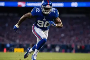 Giants linebacker explosively rushing through the line during NFL game at MetLife Stadium