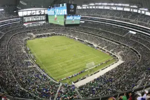 Inside AT&T Stadium during a soccer match with a large crowd.