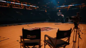 Director's chair courtside at Madison Square Garden with Knicks basketball court under dramatic lighting