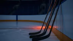 Hockey sticks on blue line representing NY Islanders defensive decision between DeAngelo, Nemec, and Spence