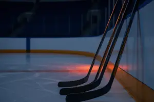 Hockey sticks on blue line representing NY Islanders defensive decision between DeAngelo, Nemec, and Spence
