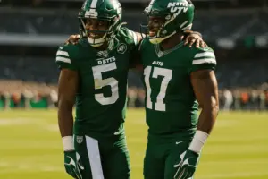 Two New York Jets players celebrating together on sideline showing team camaraderie and mutual respect