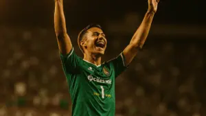 Soccer striker celebrating goal at packed stadium during World Cup knockout match