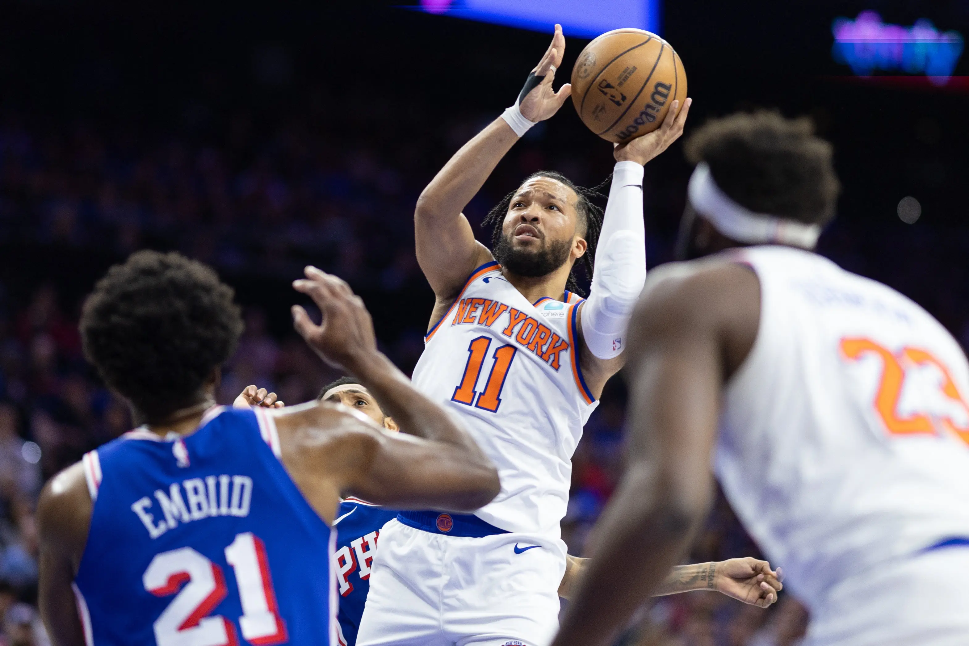 New York Knicks player shooting a basketball during an NBA game.