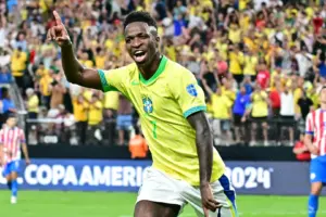Vinicius Junior celebrating after scoring for Brazil in a football match.