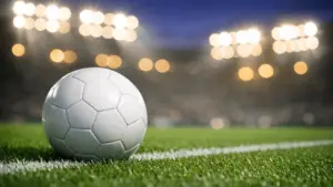 Soccer ball on stadium field under bright lights for World Cup betting