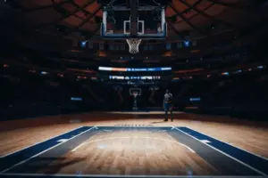 Empty basketball paint area under hoop showing defensive void in NBA arena lighting