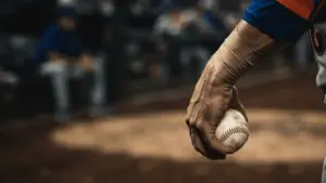 Baseball pitcher's strained forearm gripping ball, representing Mets bullpen injury crisis