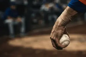 Baseball pitcher's strained forearm gripping ball, representing Mets bullpen injury crisis