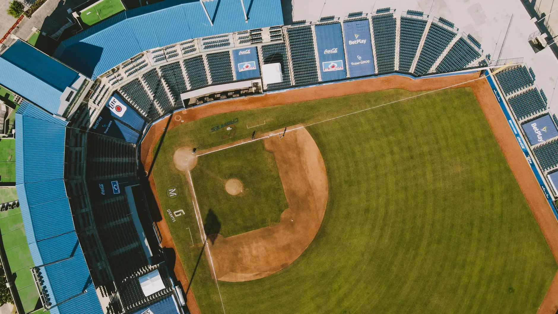 Aerial view of a baseball field with infield dirt and outfield grass.