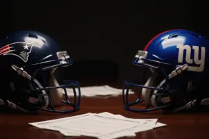 Patriots and Giants helmets facing each other across negotiation table representing trade discussion