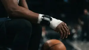 Basketball player's wrist in medical wrap symbolizing Jalen Brunson's summer surgery and recovery timeline