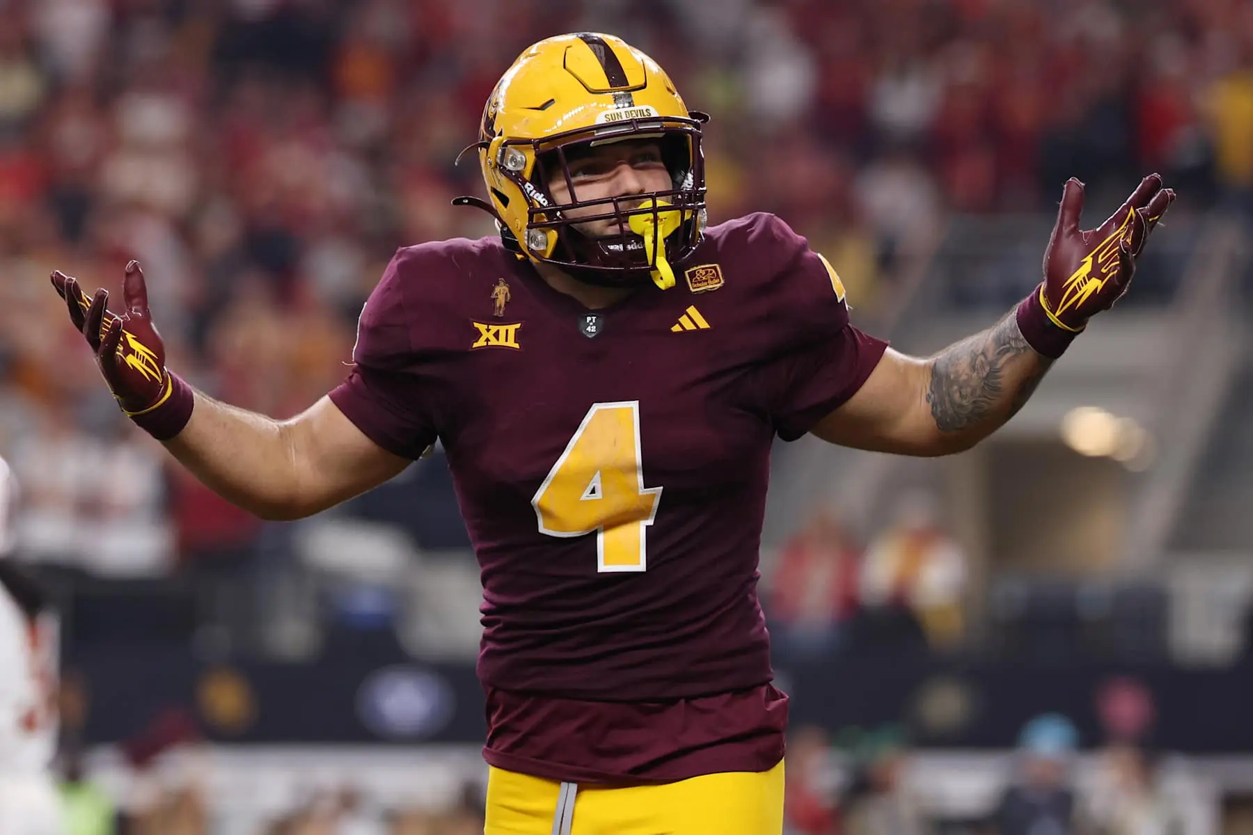 Player in Arizona State Sun Devils uniform celebrating on the field.