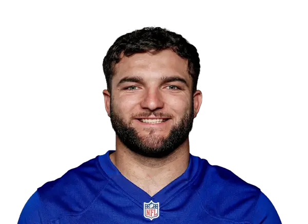Portrait of Cam Skattebo wearing a blue NFL jersey, smiling confidently.