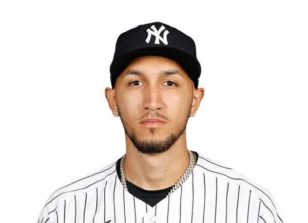 Elmer Rodriguez wearing a New York Yankees jersey and cap.