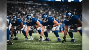 New York Giants offensive linemen in protective stance on line of scrimmage under stadium lights