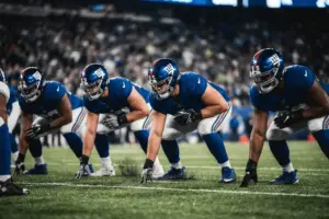 New York Giants offensive linemen in protective stance on line of scrimmage under stadium lights