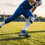 Giants player performing cutting drill during training camp recovery work on practice field
