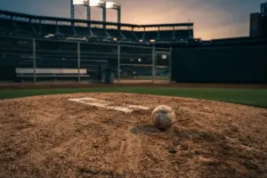 Empty bullpen mound at Citi Field with baseball at twilight, dramatic lighting showing baseball relief tension