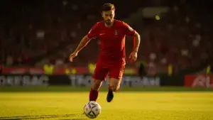 Portugal soccer player in action during World Cup knockout match with dramatic stadium lighting
