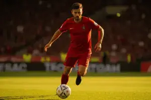 Portugal soccer player in action during World Cup knockout match with dramatic stadium lighting