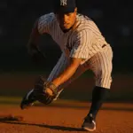 Yankees shortstop fielding ground ball during game at Yankee Stadium